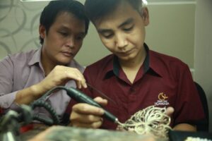 Mr. Ho Thanh Tuan and Hoang Gia Pearl artisans working on the Miss Vietnam 2014 crown during its three-month handcrafted production process